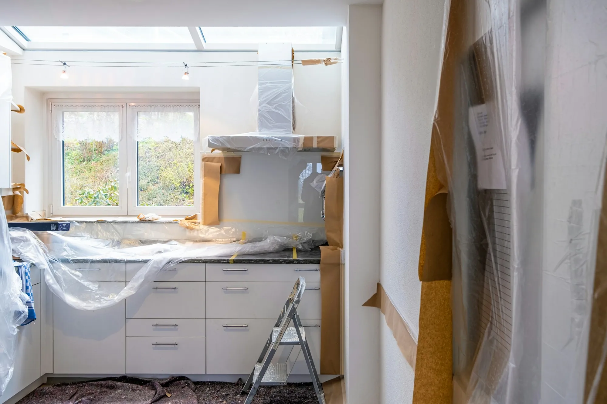 Kitchen covered in plastic sheeting during a remodel