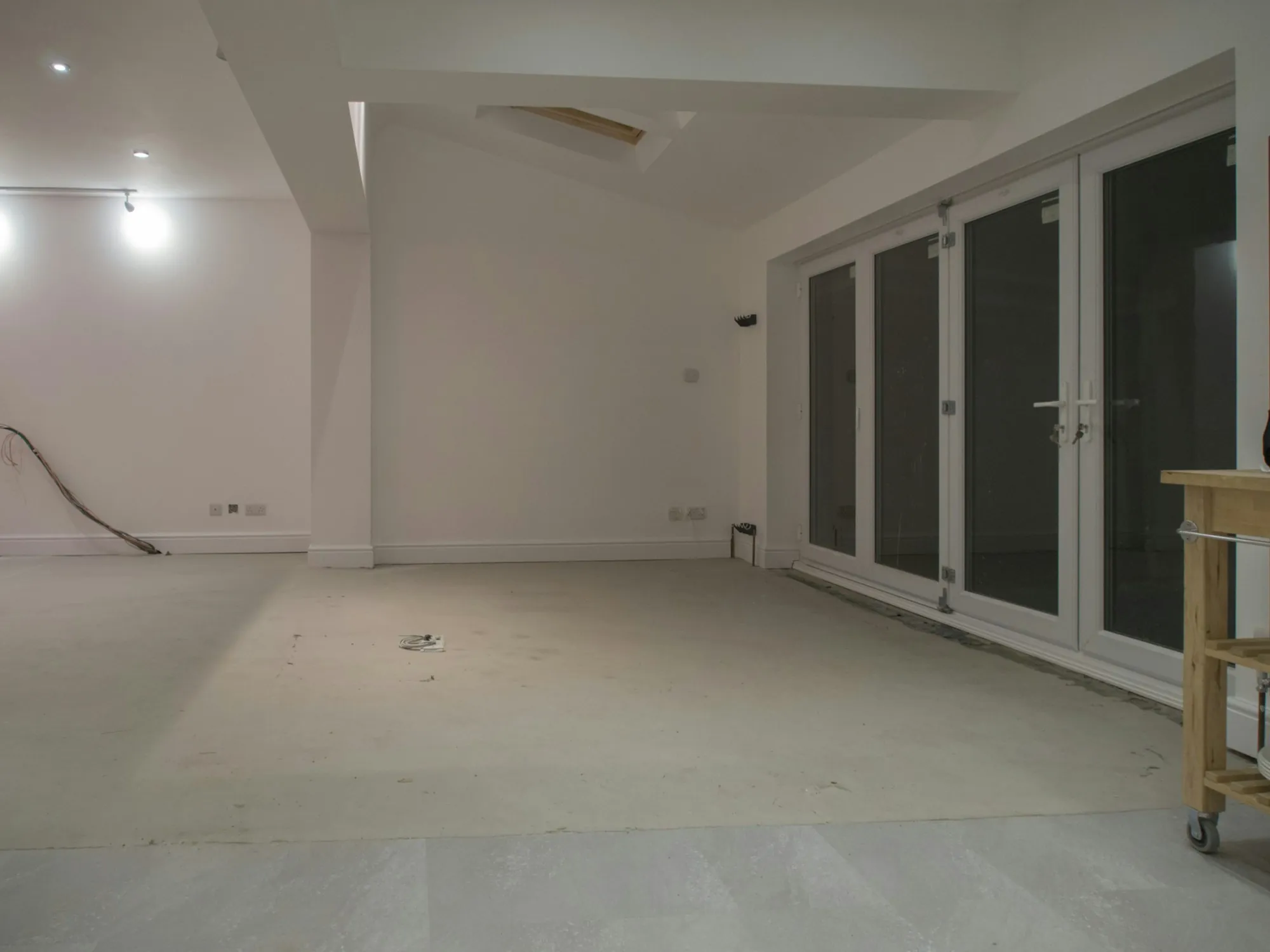 Empty finished room with new flooring and glass doors