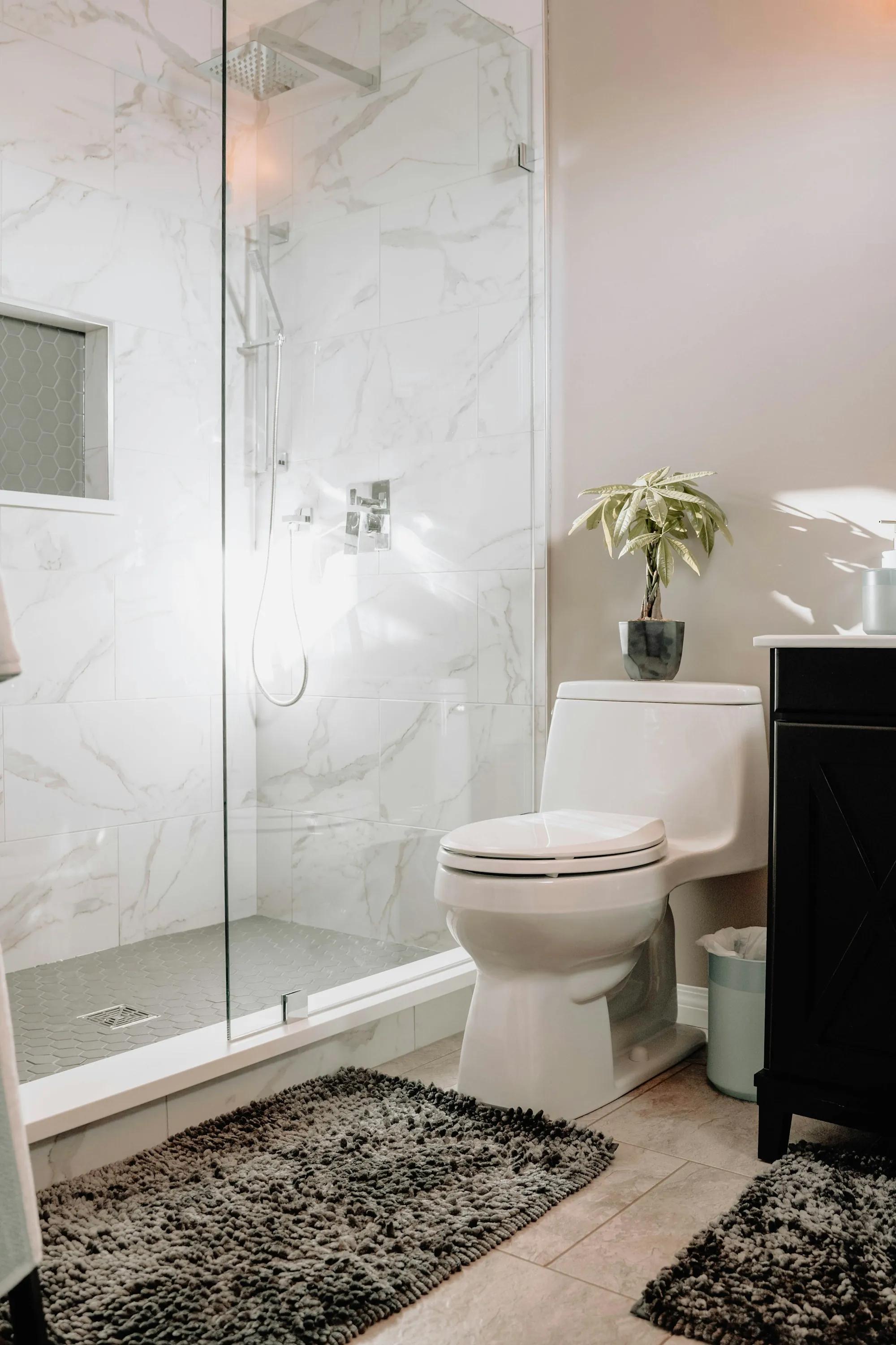 Bathroom with marble tile and a glass shower